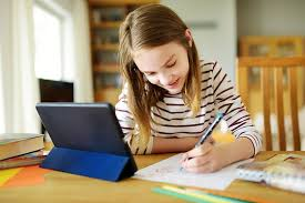 little girl being tutored online