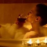 woman relaxing in a bubble bath with red wine, known as wine majic.